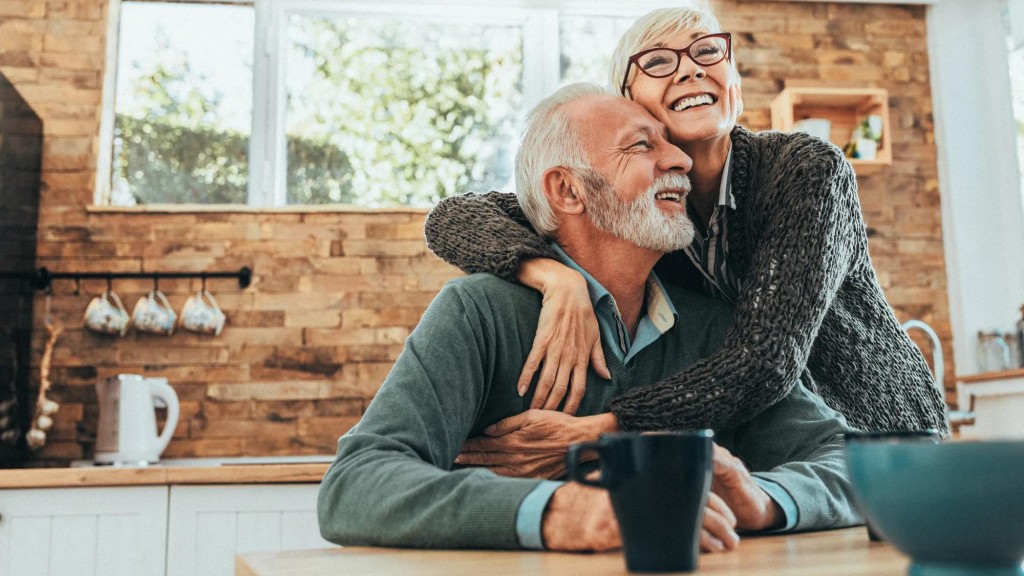 Senior female with glasses embracing a male senior, both are smiling Senior female with glasses embracing a male senior, both are smiling